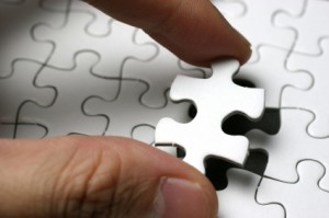 man fitting puzzle in piece