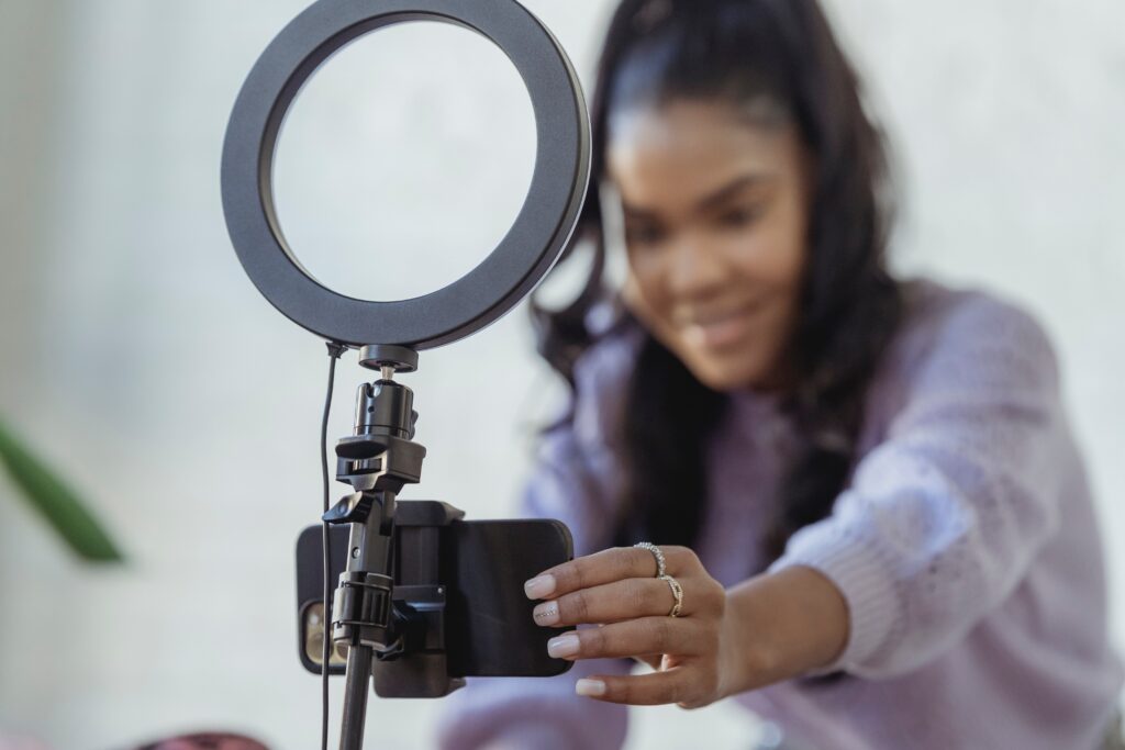 image of a woman and a ring light on a blog post on how to Repurpose Short Videos